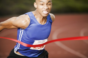 Athlete Running Through Finish Line