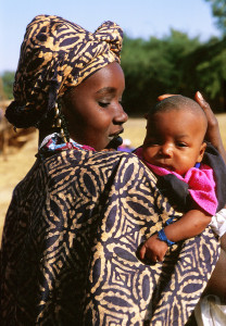 Portrait of an African mother holding her new baby. Mali.