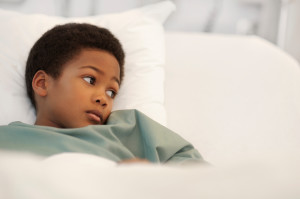 Black-child-layingin-hospital-bed