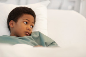 Black-child-layingin-hospital-bed-300x199